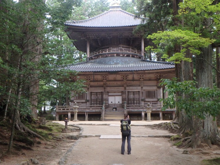 girl taking a photo of a temple